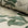 Cream and green floral printed linen fabric by the yard, rolled bolt view