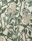 Cream and green floral printed linen fabric by the yard, folded showing drape and weight