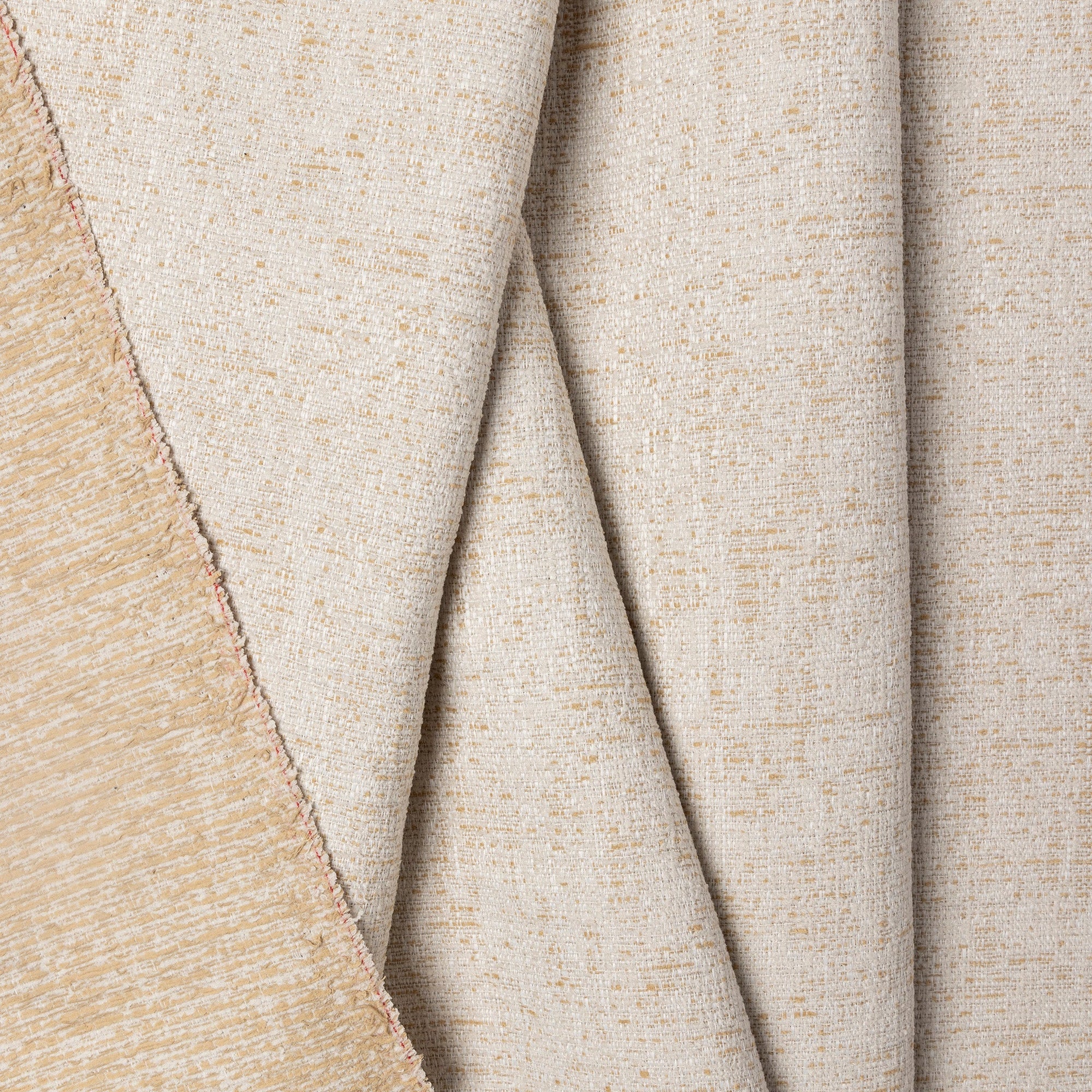 Beige marled chenille outdoor fabric by the yard, folded showing drape and weight