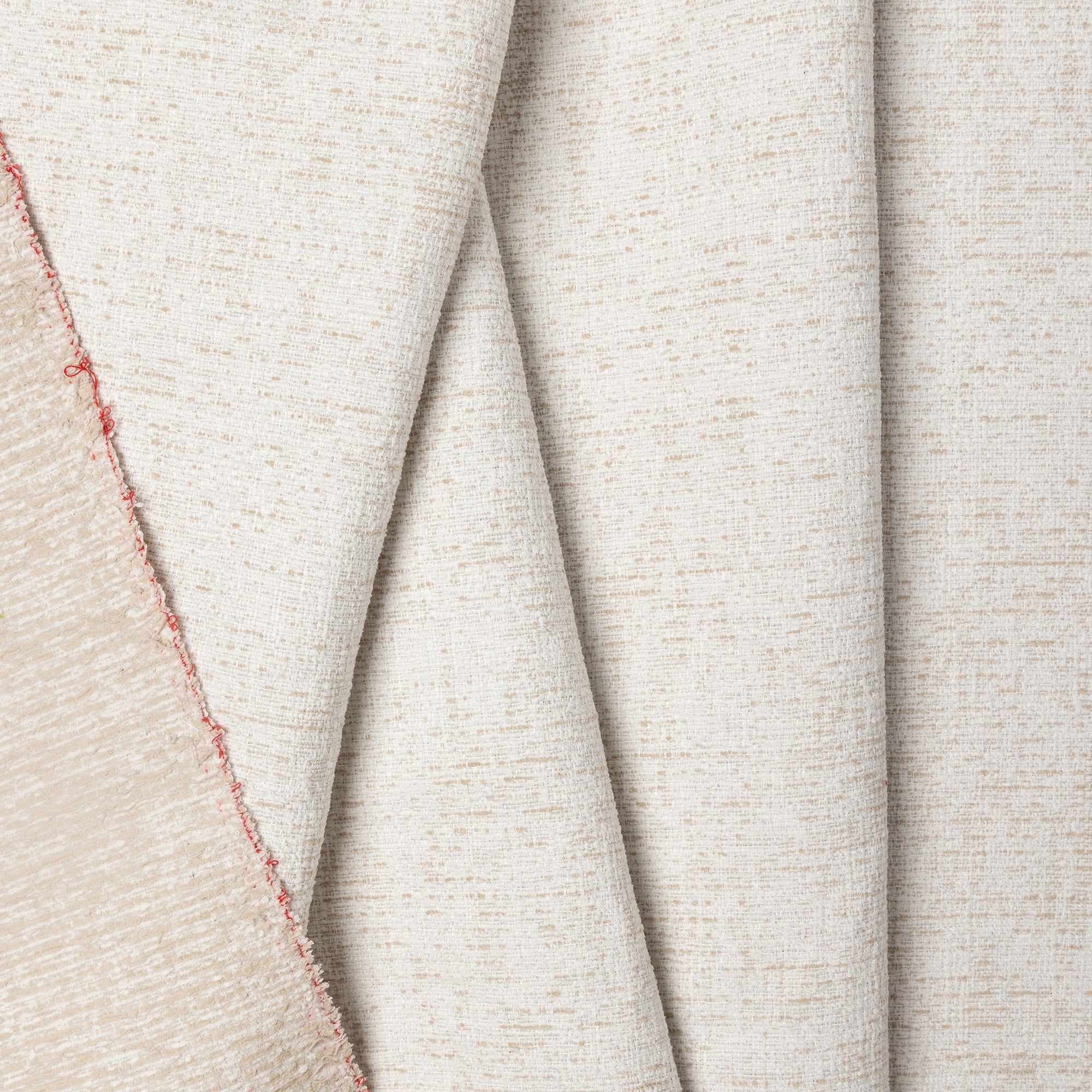 Cream marled chenille outdoor fabric by the yard, folded showing drape and weight
