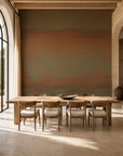 Copper and olive sunset ombre mural wallpaper installed in a sunlit dining room