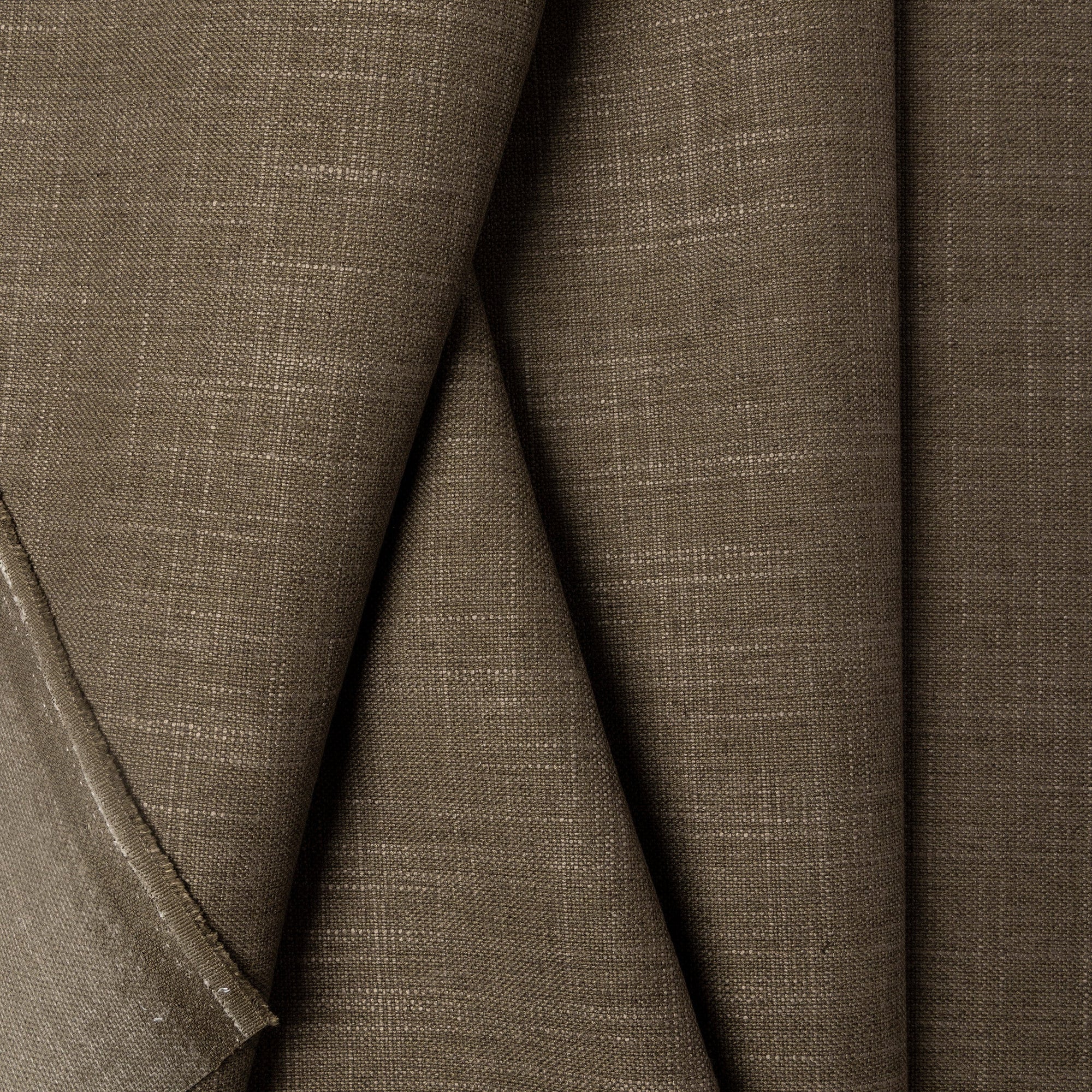 Green linen upholstery fabric by the yard, folded showing drape and weight