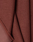 Red linen upholstery fabric by the yard, folded showing drape and weight