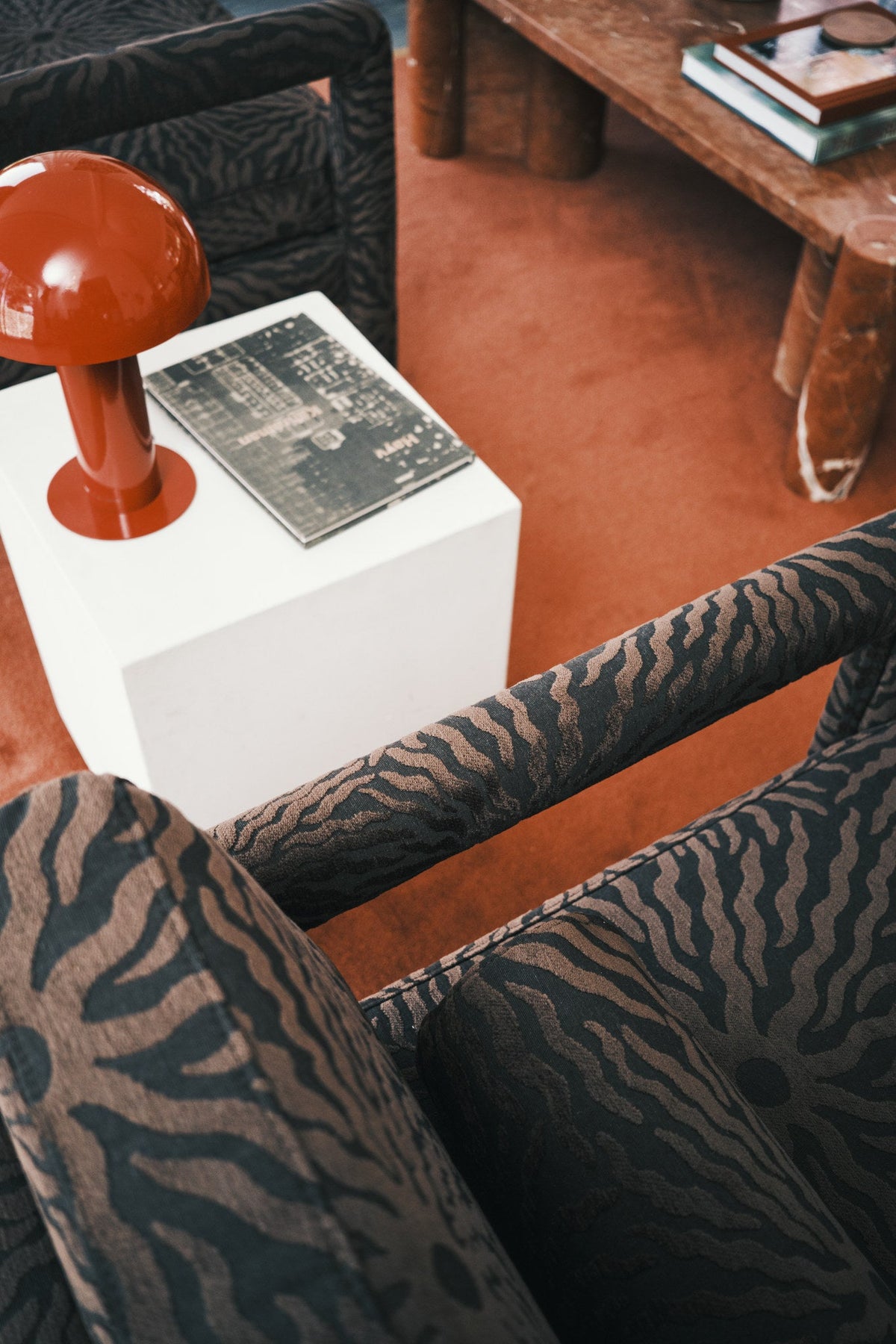 Brown sunburst jacquard fabric upholstered on a chair seen from above in a modern lounge