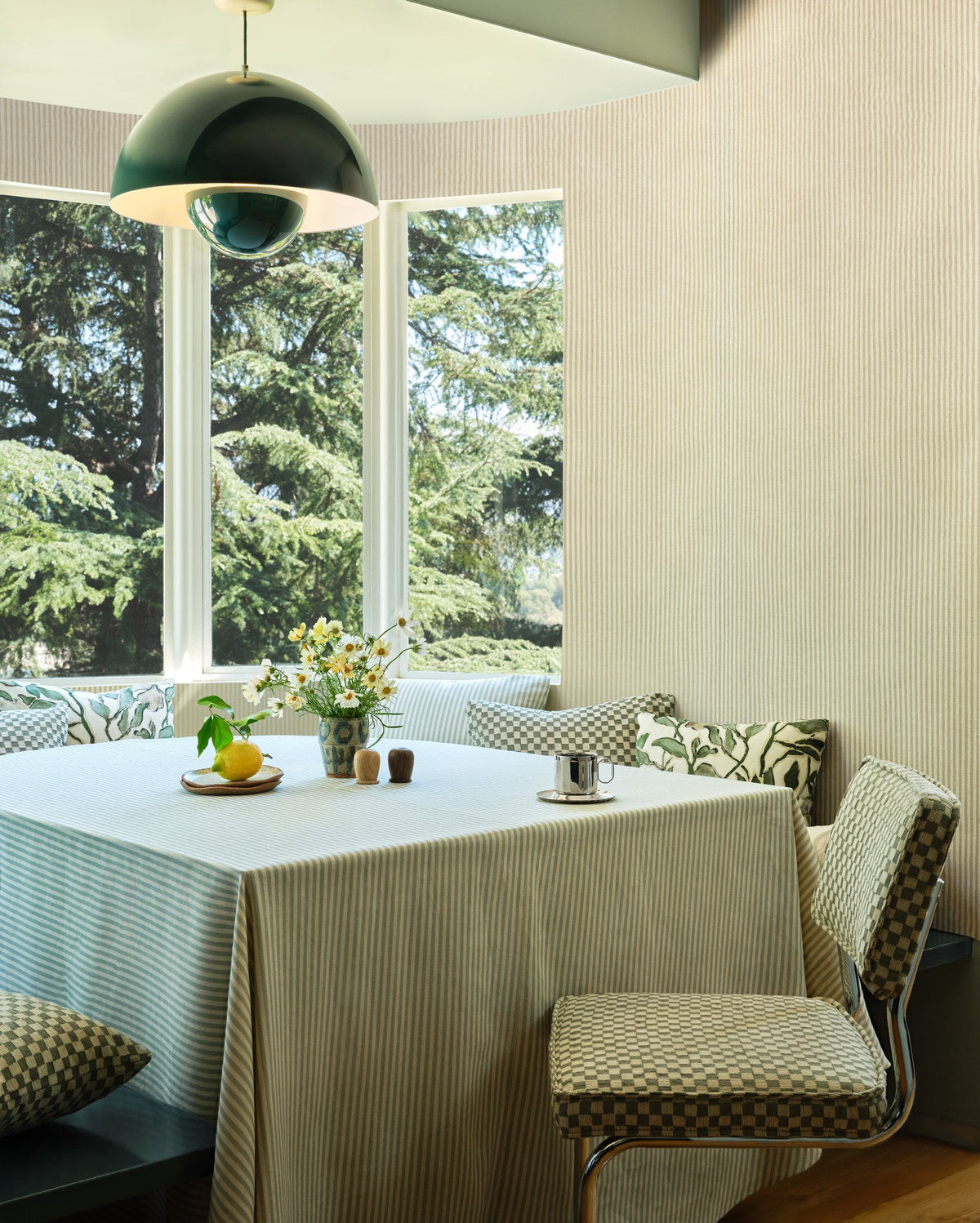 Olive green checkerboard jacquard fabric upholstered on a chair with matching pillows