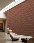 Terracotta stippled petal geometric wallpaper installed in a skylit lounge