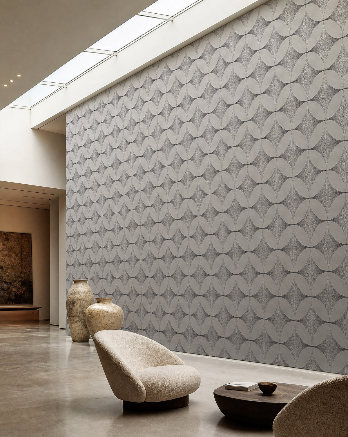 Light gray stippled petal geometric wallpaper installed in a skylit lounge