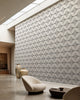 White and black stippled petal geometric wallpaper installed in a skylit lounge