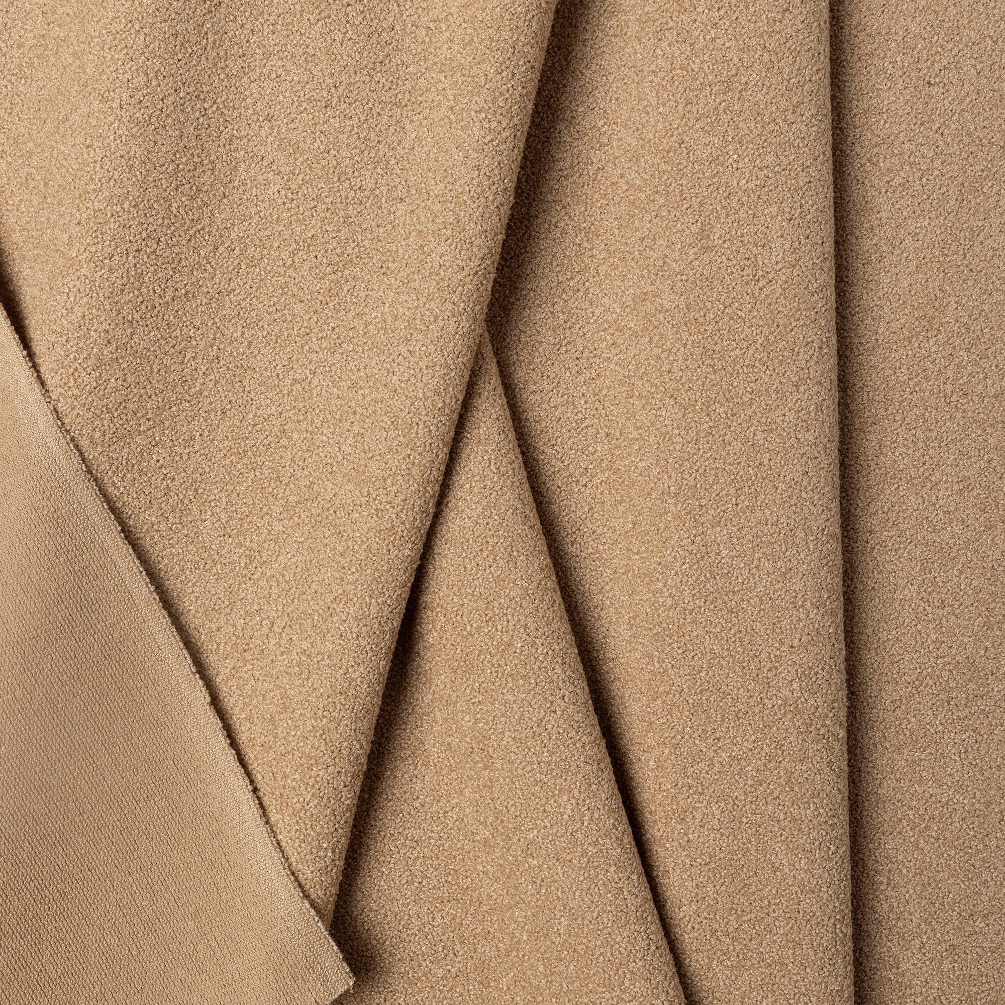 Beige boucle upholstery fabric by the yard, folded showing drape and weight