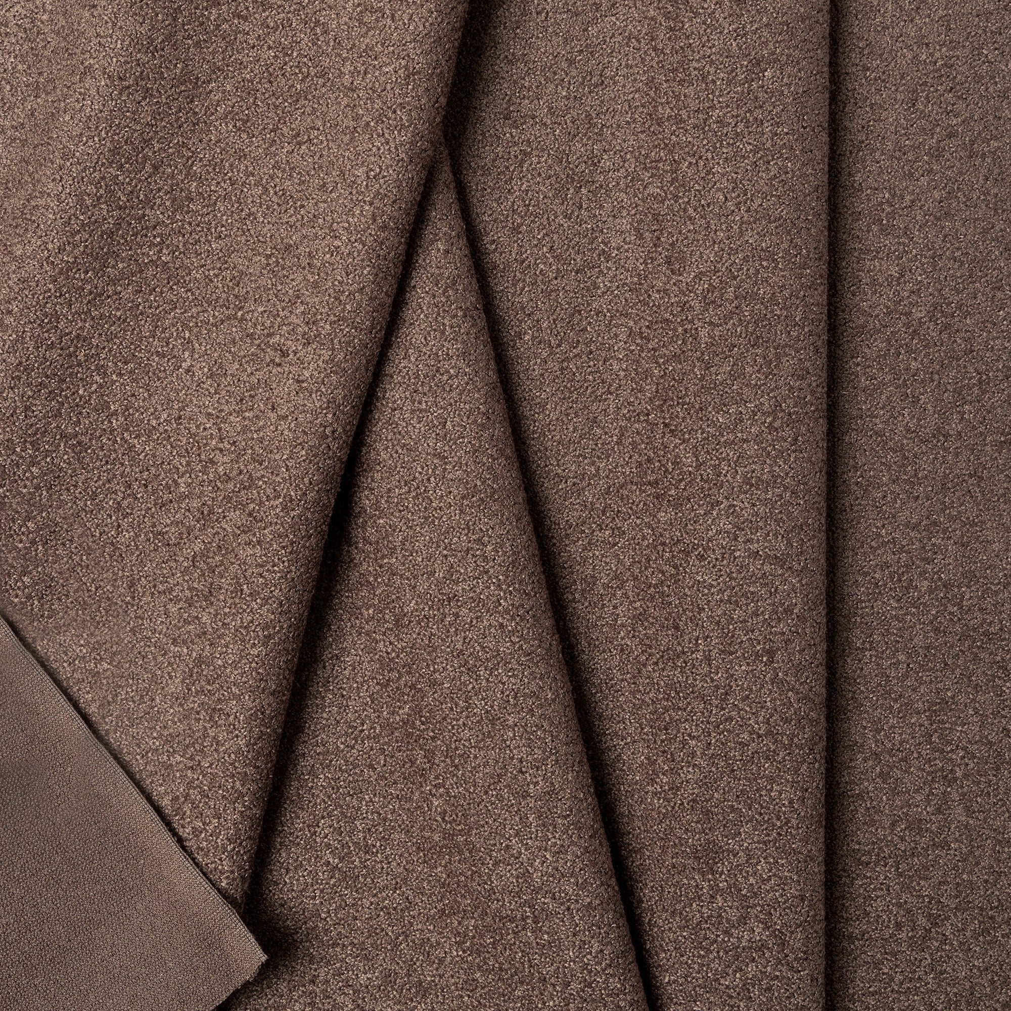 Brown boucle upholstery fabric by the yard, folded showing drape and weight
