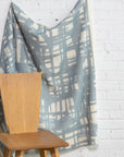 Blue and cream brushstroke crosshatch linen fabric by the yard, draped to show pattern and scale