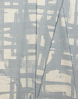 Blue and cream brushstroke crosshatch linen fabric by the yard, folded showing drape and weight