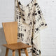 Cream and black brushstroke crosshatch linen fabric by the yard, draped to show pattern and scale