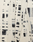 Cream and black brushstroke crosshatch linen fabric by the yard, folded showing drape and weight