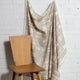Natural cream brushstroke crosshatch linen fabric by the yard, draped to show pattern and scale