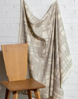 Natural cream brushstroke crosshatch linen fabric by the yard, draped to show pattern and scale