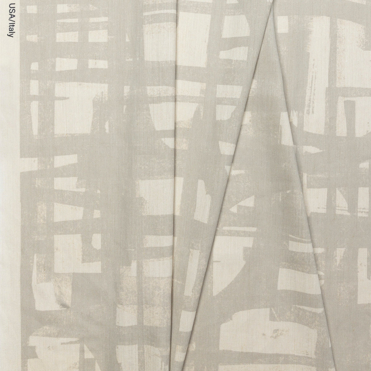 Natural cream brushstroke crosshatch linen fabric by the yard, folded showing drape and weight