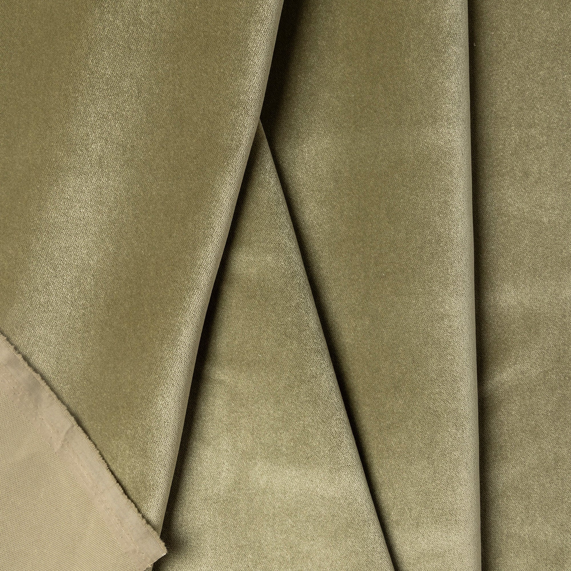 Green velvet upholstery fabric by the yard, folded showing drape and weight