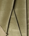 Green velvet upholstery fabric by the yard, folded showing drape and weight