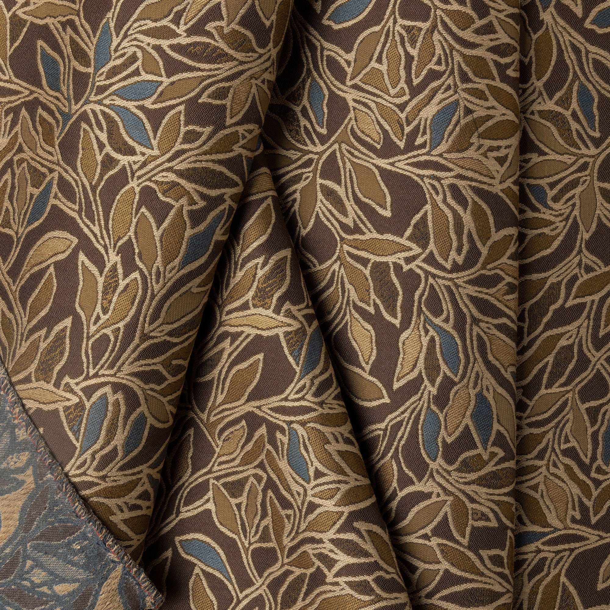 Brown botanical leaf jacquard upholstery fabric by the yard, folded showing drape and weight