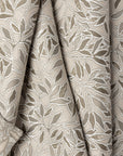 Cream botanical leaf jacquard upholstery fabric by the yard, folded showing drape and weight