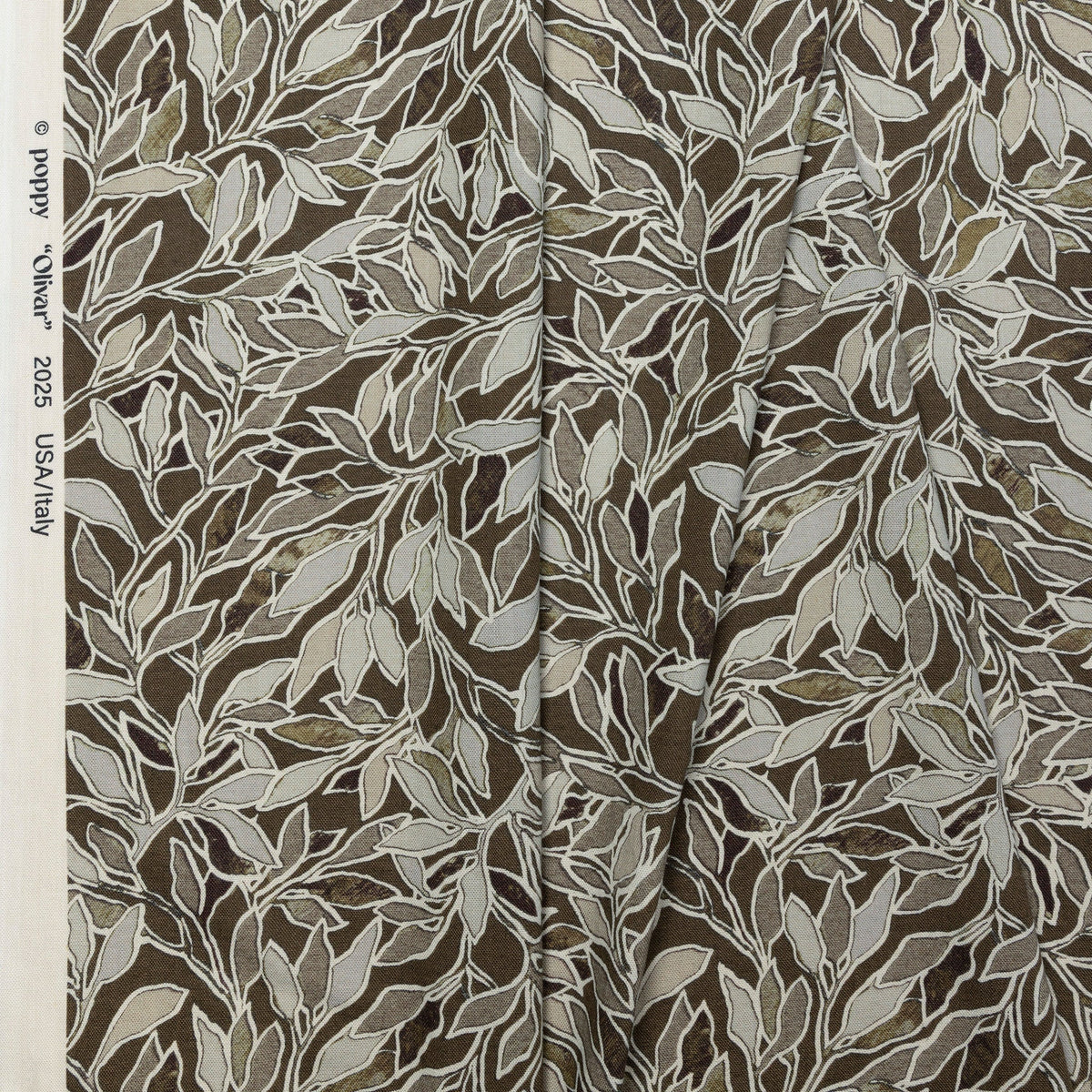 Brown and cream botanical leaf printed linen fabric by the yard, folded showing drape and weight