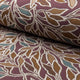 Deep maroon with teal botanical leaf jacquard upholstery fabric by the yard, rolled bolt view