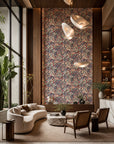 Pink and plum fruit and floral botanical wallpaper installed in a double-height lounge