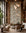Brown and rust botanical on white wallpaper installed in a double-height lounge