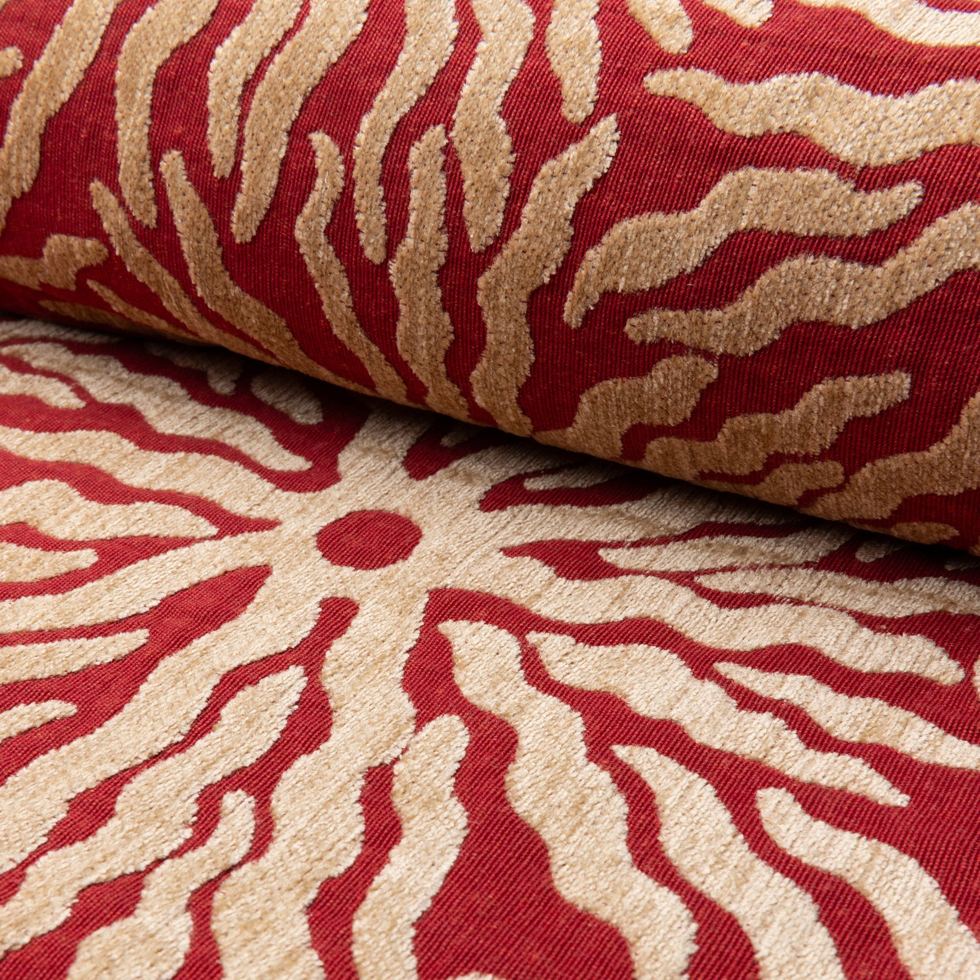 Red and gold sunburst jacquard upholstery fabric by the yard, rolled bolt view
