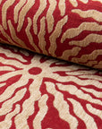 Red and gold sunburst jacquard upholstery fabric by the yard, rolled bolt view
