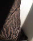 Close-up of woven sunburst pattern on dark brown jacquard throw pillow