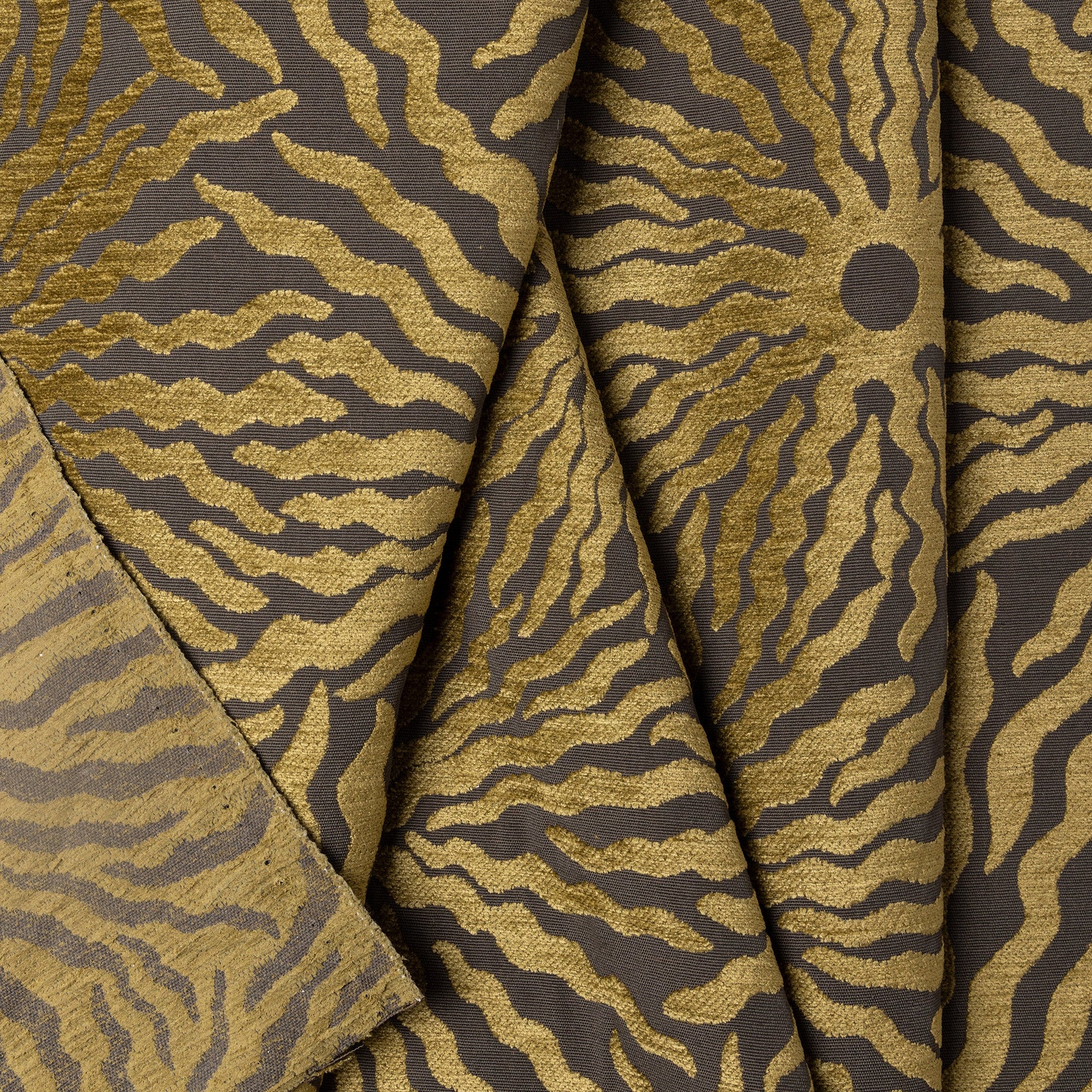 Gold and brown sunburst jacquard upholstery fabric by the yard, folded showing drape and weight