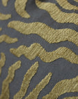 Close-up of woven sunburst pattern on gold and brown jacquard throw pillow