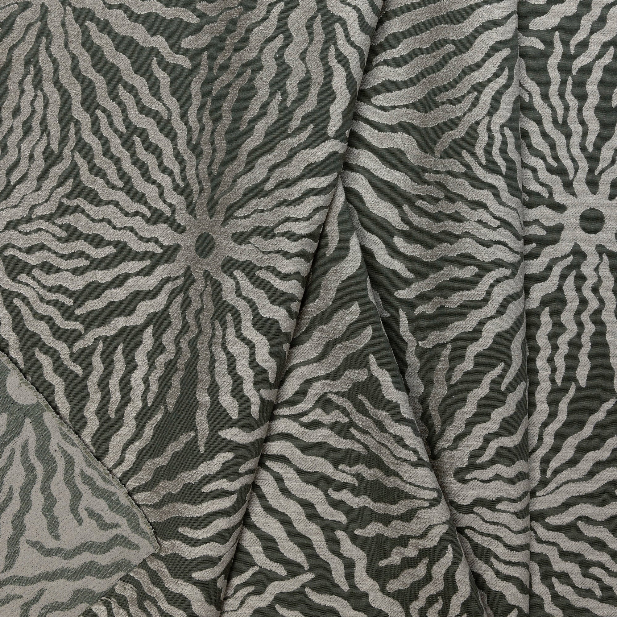 Gray sunburst jacquard upholstery fabric by the yard, folded showing drape and weight