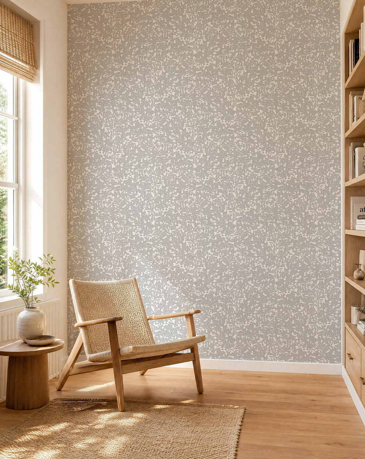 Light gray and white abstract squiggle commercial wallcovering installed in a sunlit reading nook