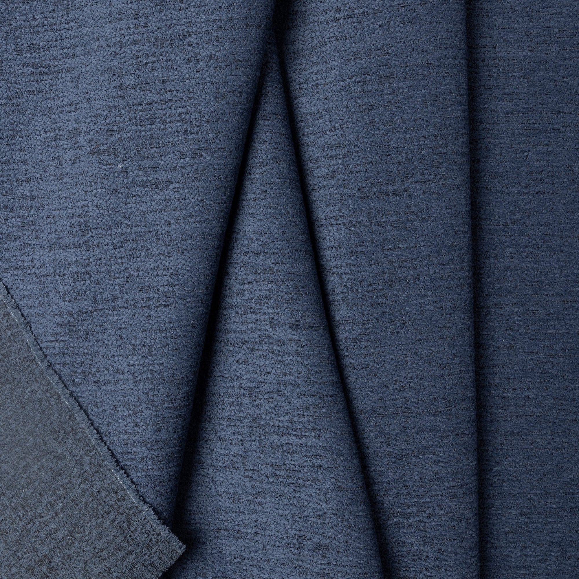 Blue chenille outdoor fabric by the yard, folded showing drape and weight