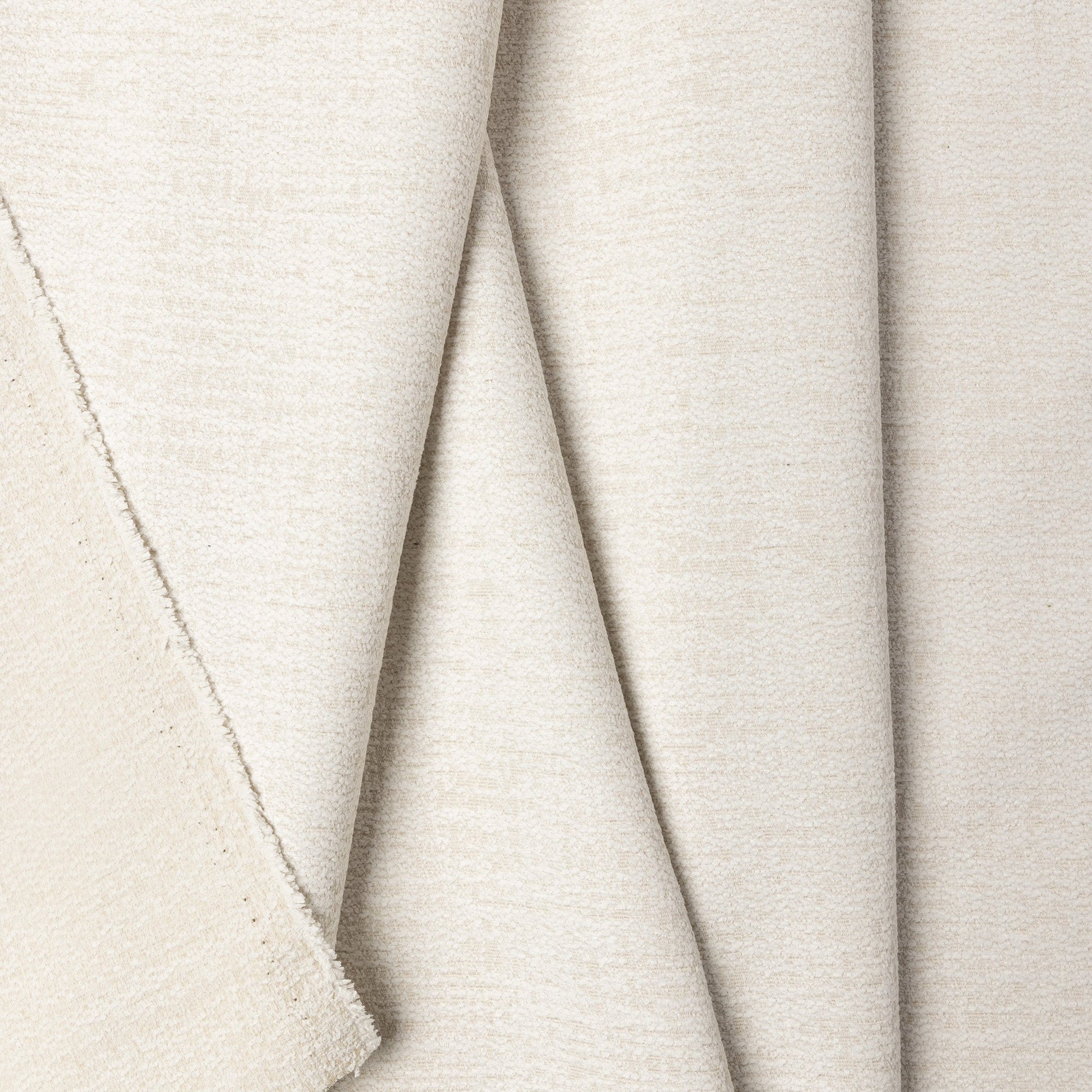 Cream chenille outdoor fabric by the yard, folded showing drape and weight