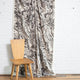 Black and cream marbled abstract linen fabric by the yard, draped to show pattern and scale