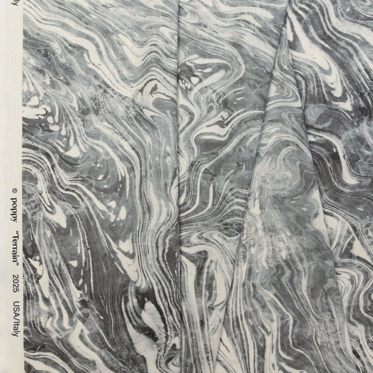 Gray and silver marbled abstract linen fabric by the yard, folded showing drape and weight