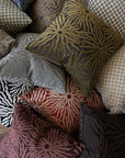 Dark brown sunburst throw pillow in Poppy Print Studio jacquard pillow collection arrangement