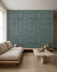 Charcoal hand-drawn grid on sage green commercial wallcovering installed in a minimalist living room