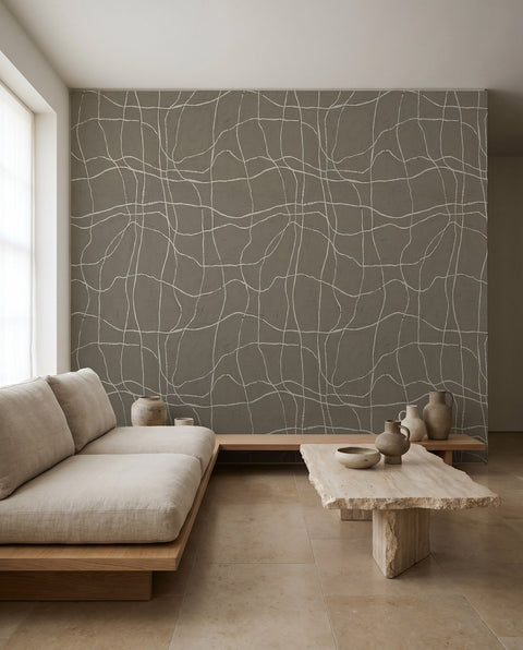 White hand-drawn grid on gray-blue wallpaper installed in a minimalist living room