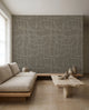 White hand-drawn grid on gray-blue wallpaper installed in a minimalist living room