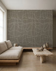 White hand-drawn grid on gray-blue wallpaper installed in a minimalist living room