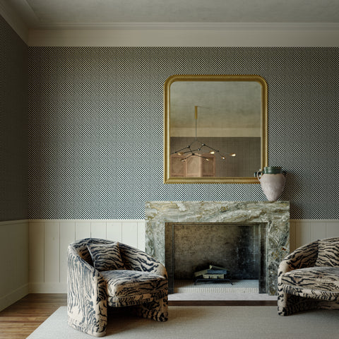 Elegant living room featuring black and white micro-checkered wallpaper, a marble fireplace, and plush tiger-print armchairs, creating a sophisticated contrast.
